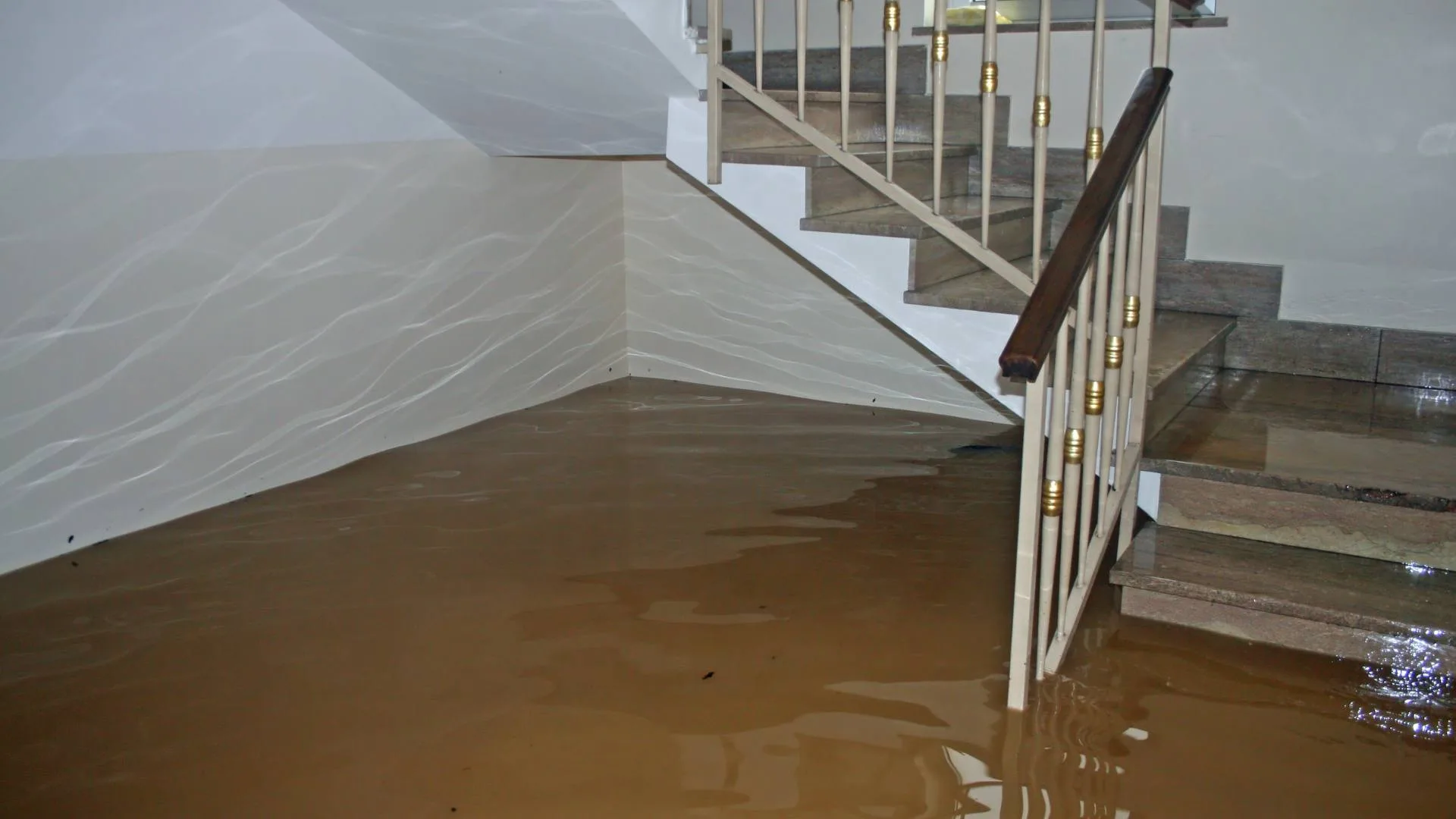 Flood water covering a basement floor and stairs