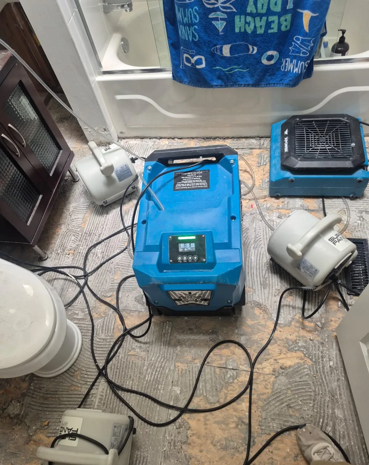 Professional drying equipment operating in a bathroom