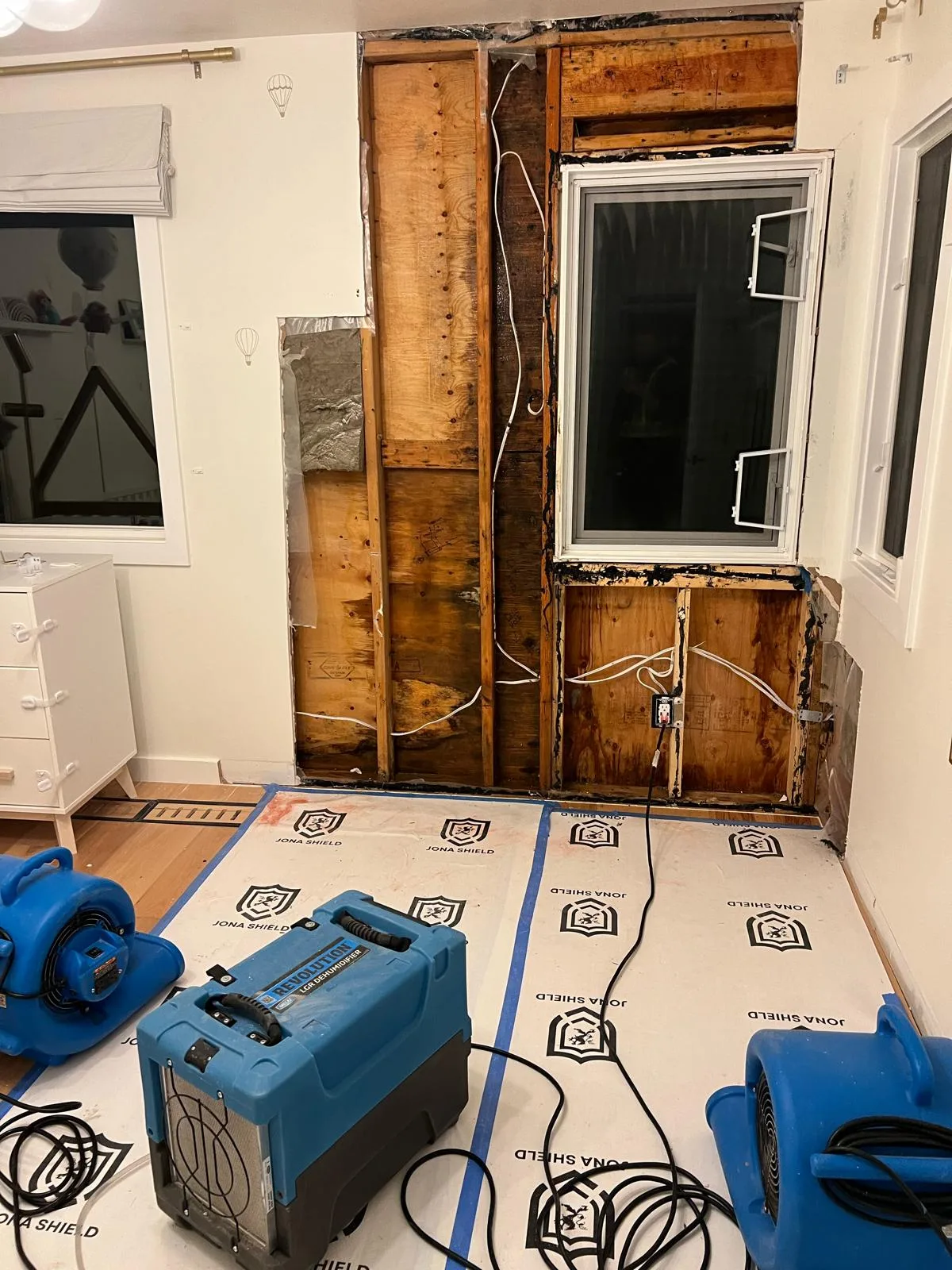 Wall opened for water damage drying and repair